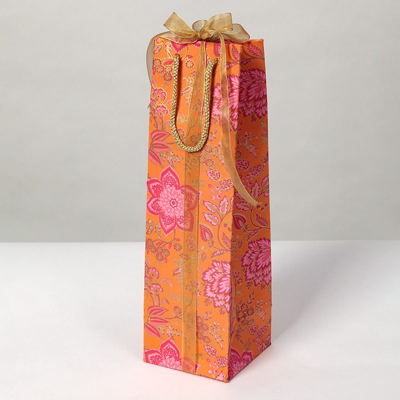 Orange floral print bottle bags with intricate detailing and a rich colour combination of hot pinks and gold has a magical quality.