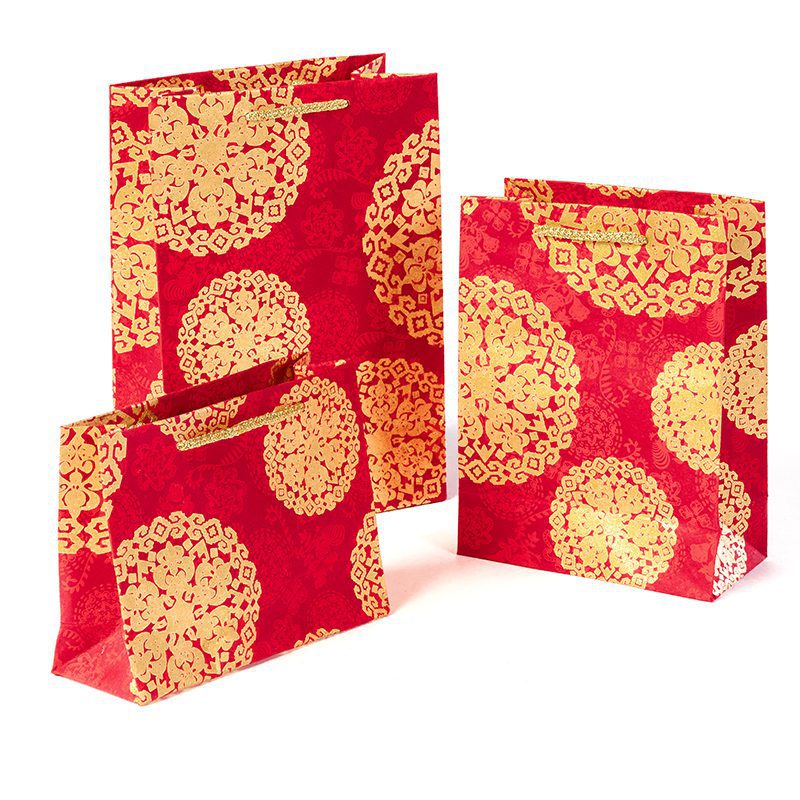 Handmade gift bags made from handmade wrapping paper are perfect for all shapes and sizes of presents, Shown here in Red medallion.